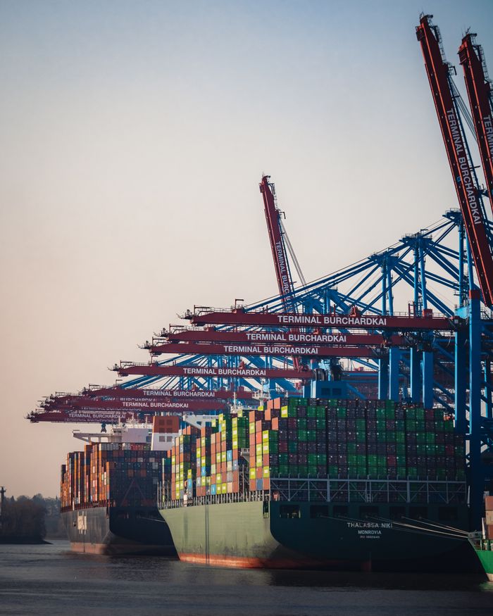 ours-journey Cargo ships and cranes at Hamburg Burchardkai Terminal during day.