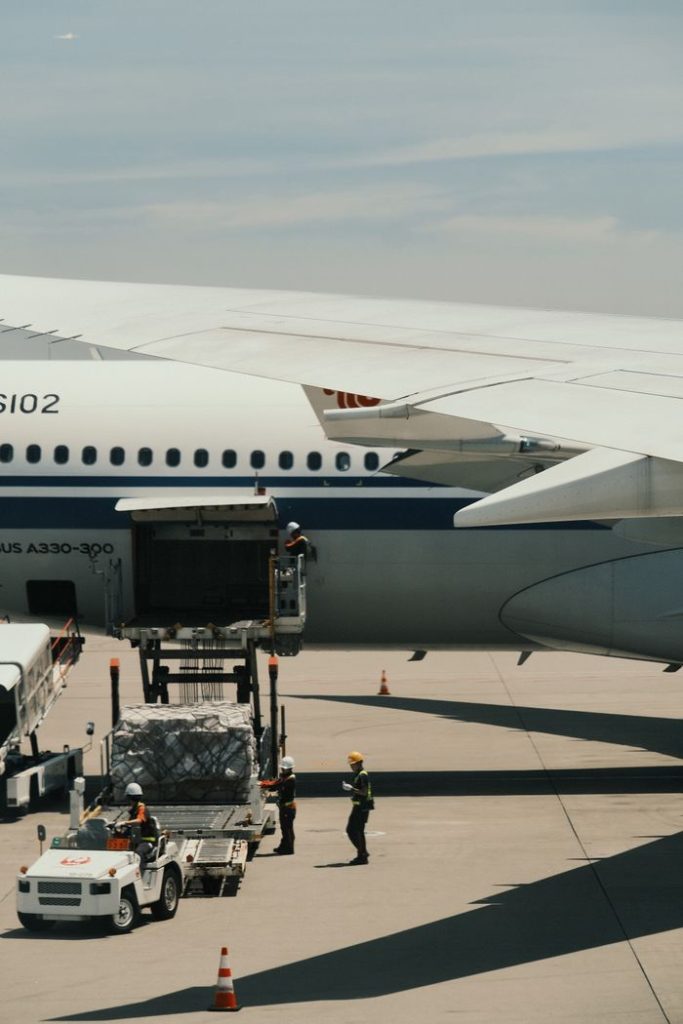 our-services-1 Airbus A330 being loaded with cargo on an airport runway, showcasing transportation logistics.