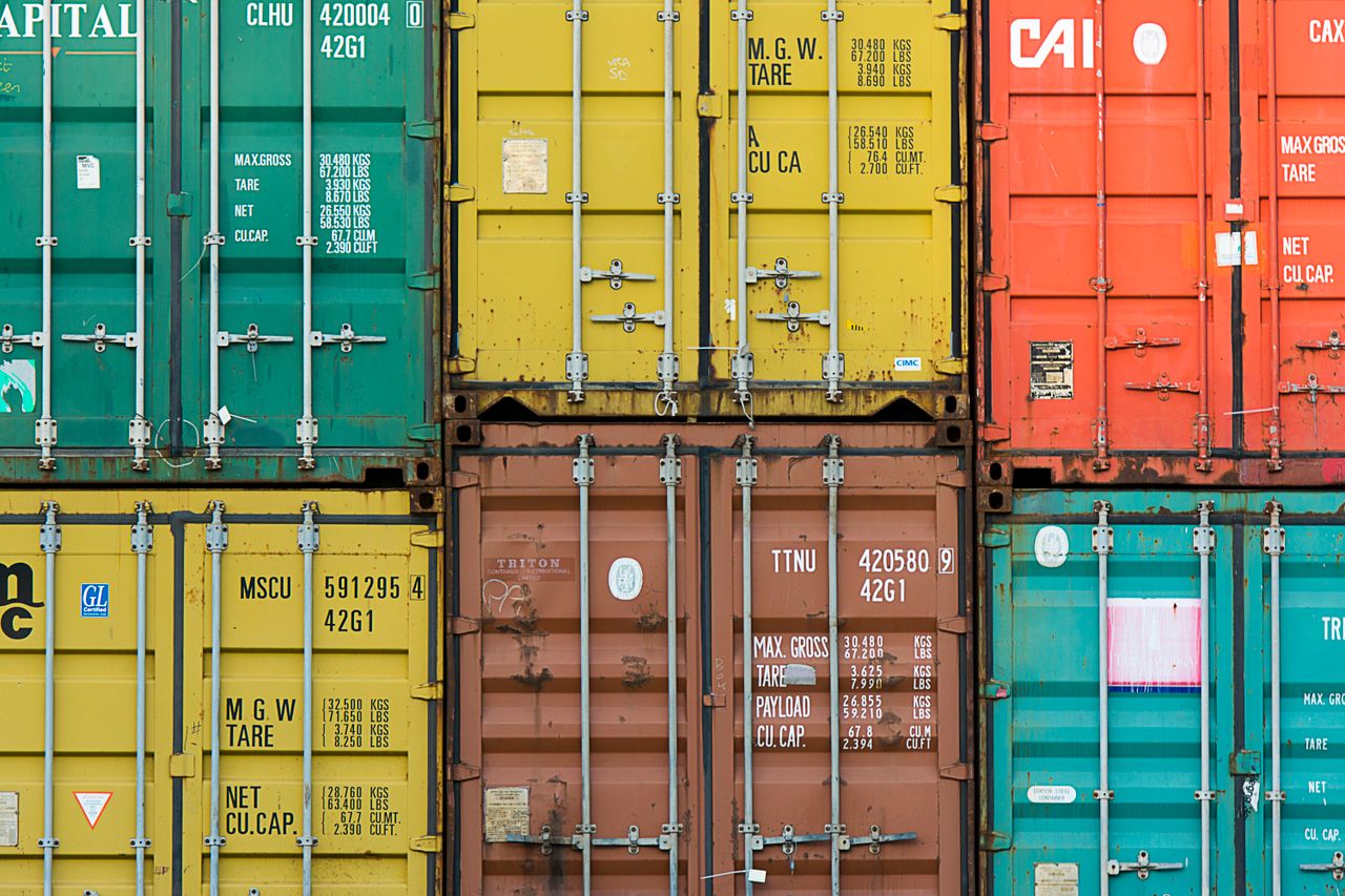 services-01 Vibrant cargo containers stacked in a shipping yard highlighting global trade.